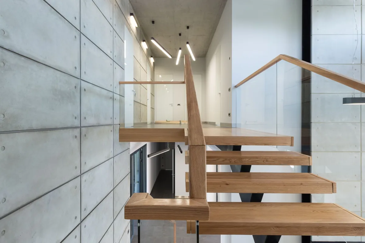Open-tread oak staircase with a glass balustrade in a modern home