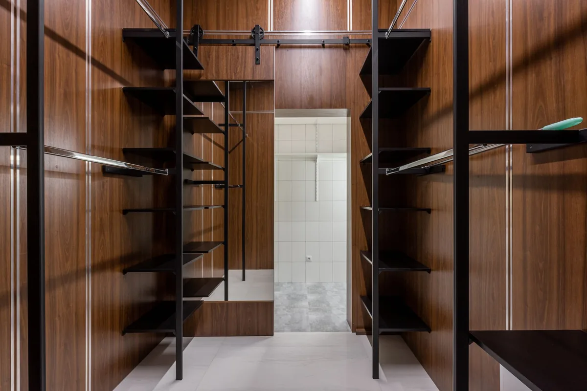 Dressing room fitted with oak shelving and hanging space