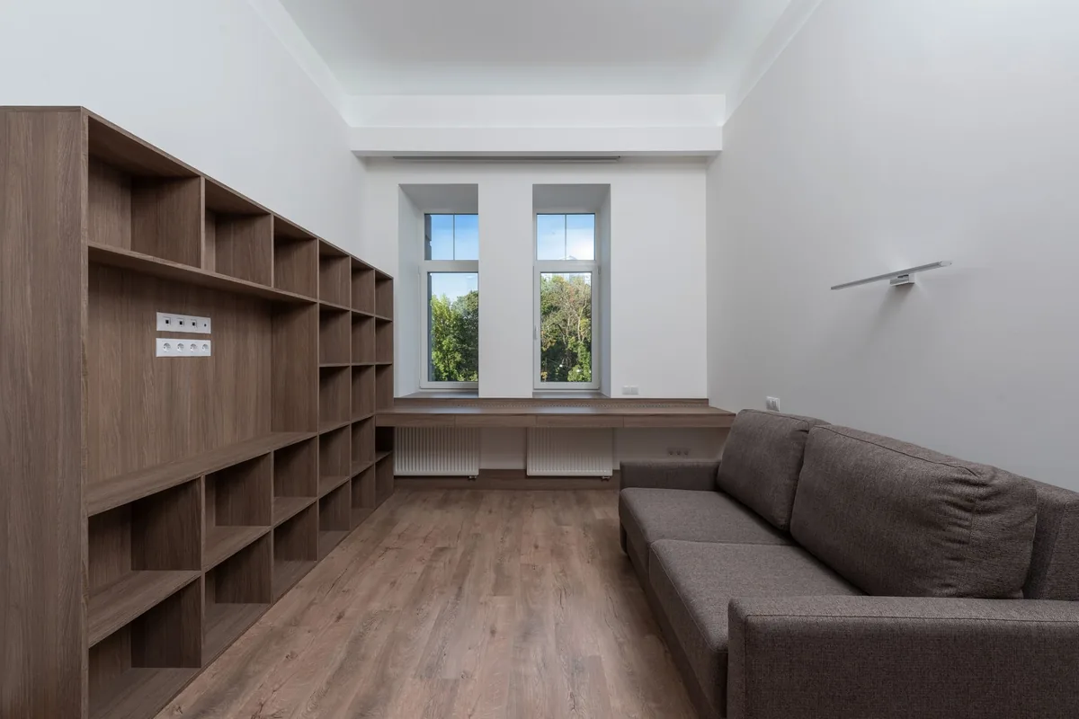 Floor-to-ceiling fitted shelving built into a living room