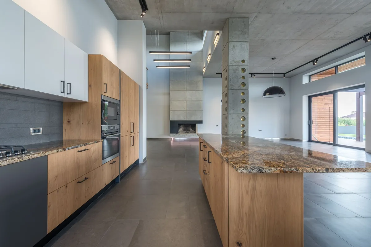 Oak kitchen with a large island and integrated ovens