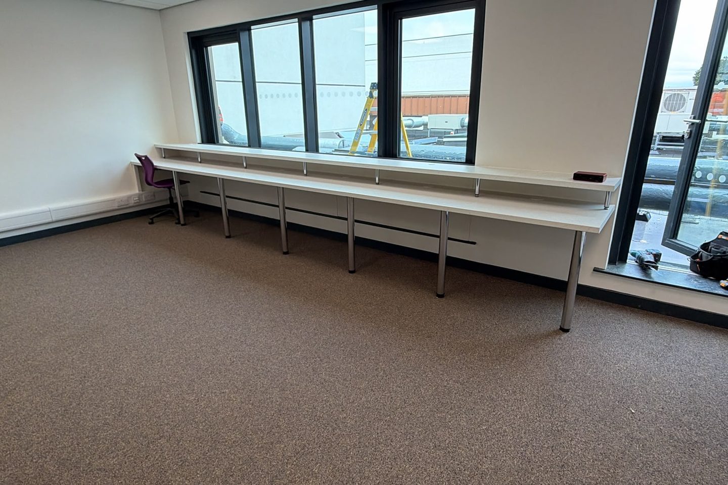 Bench run fitted under a window, worked around the existing dado trunking