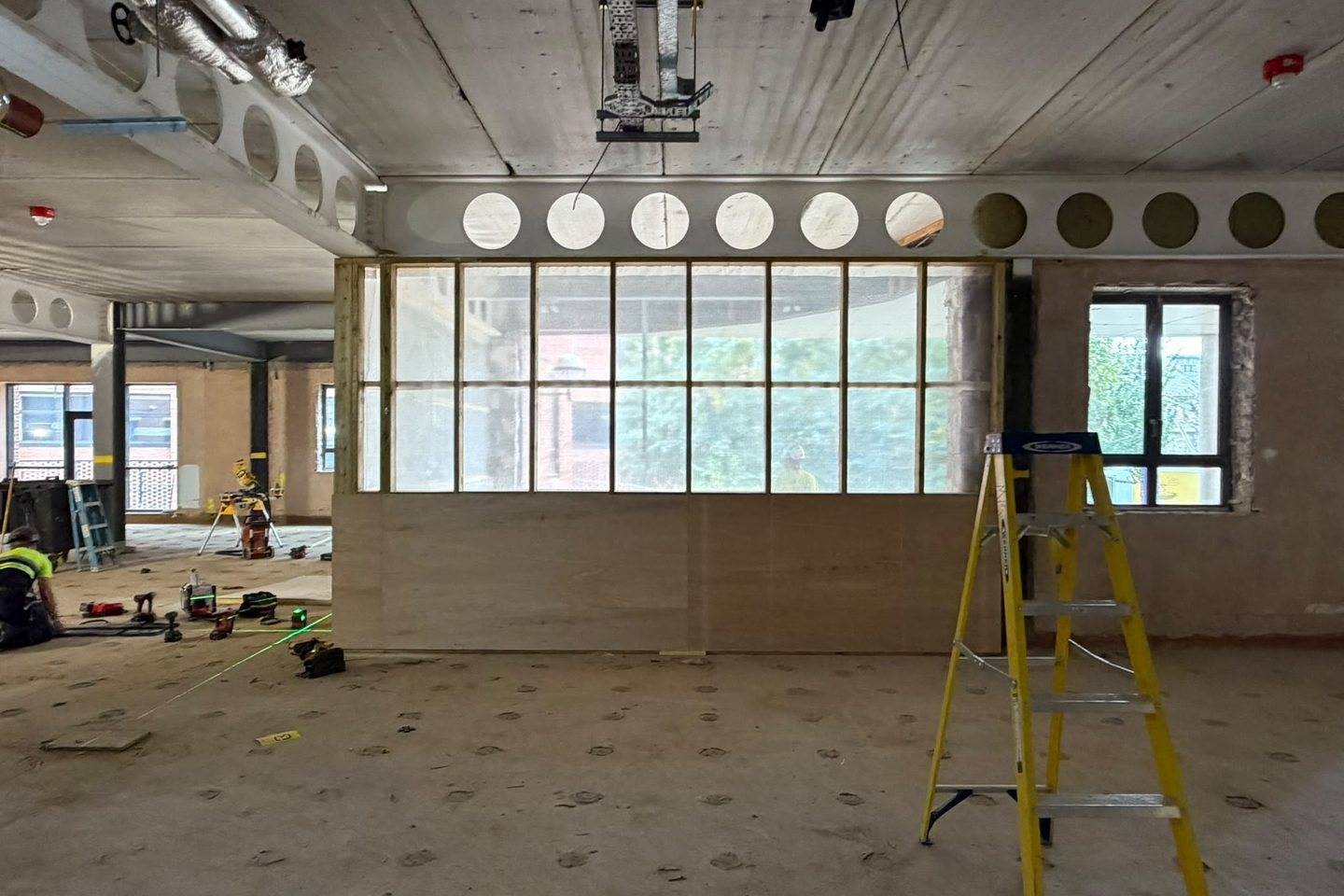 Stud partition set out from green laser lines marked across the floor